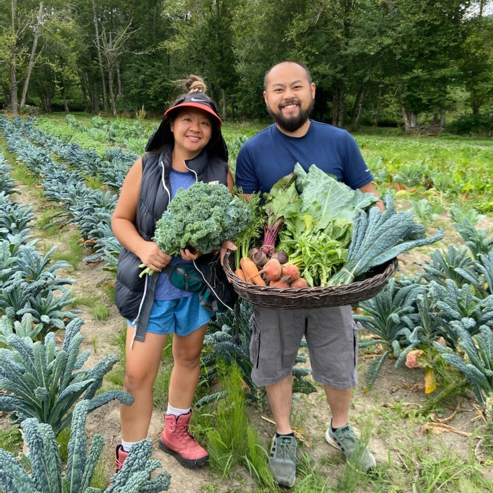 Vegetable farmers standing in front of their field