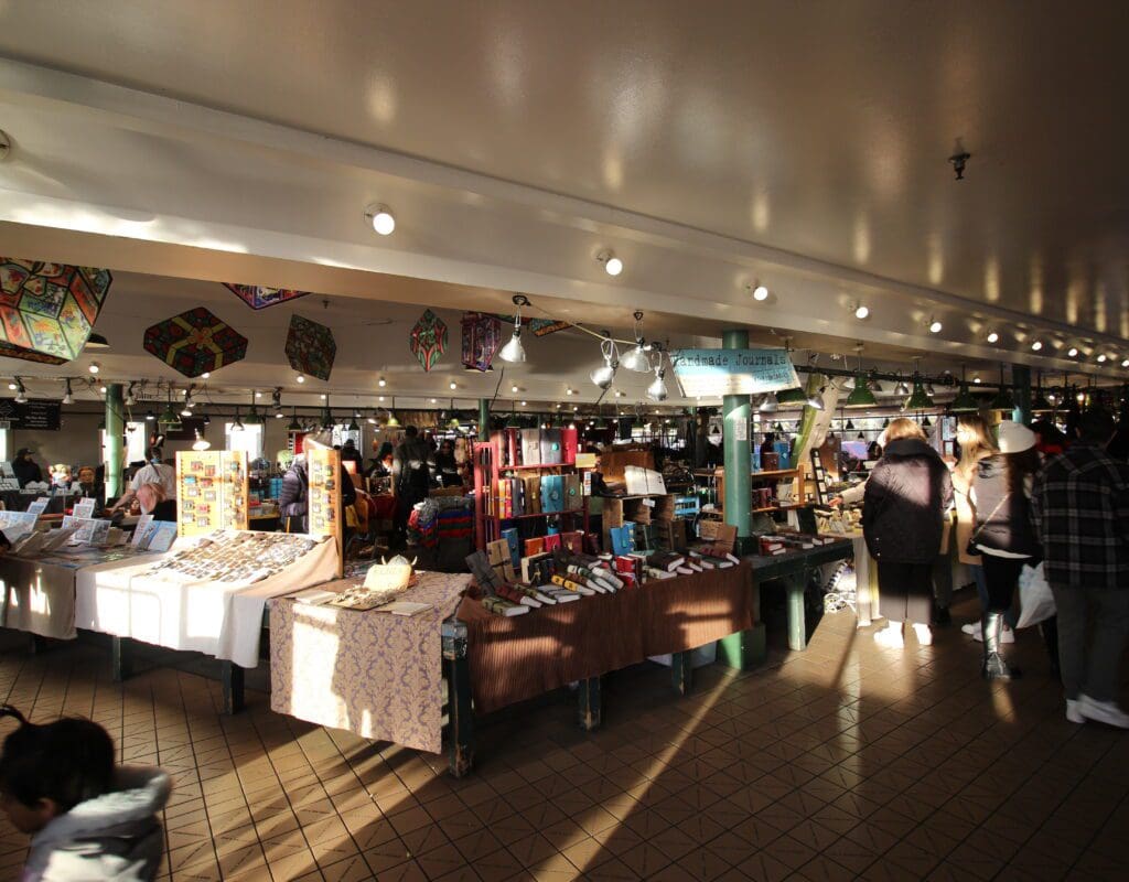 people shopping in the handmade craft market at Pike Place Market in seattle